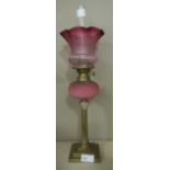 A small brass and coloured glass oil lamp with Corinthian column base,