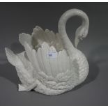 A white glazed ceramic jardiniere in the form of a swan