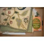 A crewel work cushion cover; a frame for needlework embroidery; sewing patterns, needles,