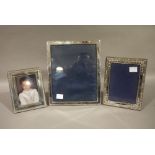 Three silver photograph frames