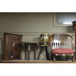 A small oak wall hanging corner cupboard with panelled door, a small brass topped table,