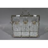 A silver plated three bottle Tantalus,