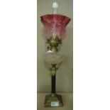A small brass and glass oil lamp with Corinthian column base,