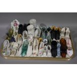 A collection of late 19th and early 20th century glass porcelain and pottery model shoes