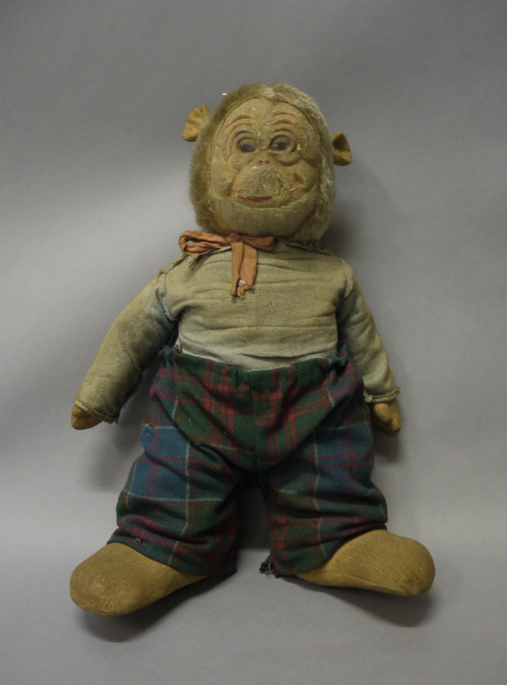 An early 20th century stuffed toy monkey, the silver plush head with composition moulded face,