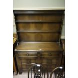 A reproduction oak dresser with two tier rack,