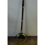 A copper and brass bed warming pan with turned stained beech handle