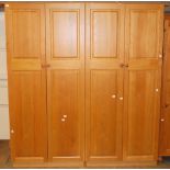 A large light oak double wardrobe with fitted mirrored interior