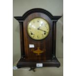 An Edwardian cased two train mantel clock with white dial, Arabic numerals,