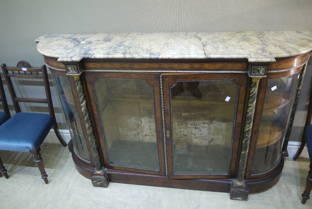 A mid Victorian walnut credenza with variegated marble top above an inlaid frieze,