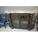 A mid Victorian walnut credenza with variegated marble top above an inlaid frieze,