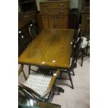 A 20th century oak refectory style draw leaf dining table,