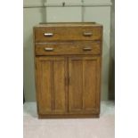 An oak tallboy with two long drawers and cupboards below, two oak floor standing open bookcases,