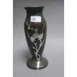 An American bronze slender ovoid vase decorated with a silver onlay decoration of flowering prunus