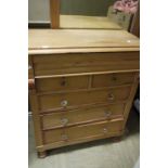 A Victorian pine chest of drawers with shaped frieze drawer,