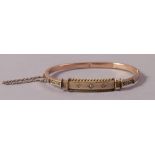 A Victorian diamond set stiff hinged bangle in 9ct rose gold,