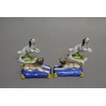 A pair of continental porcelain figures of King Charles spaniels;