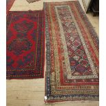 A indigo ground Caucasian rug with multiple guard stripes in red,