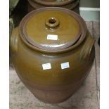 A glazed brown stoneware jar and cover