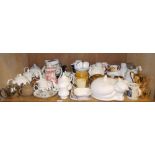 A quantity of pottery and porcelain including cat printed teapots and covers,