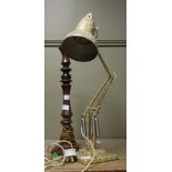 A gold and cream painted angle-poise lamp,