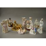 A pair of Bisque flower holders applied with figures, a Piano Baby, a composition figure of a tramp,