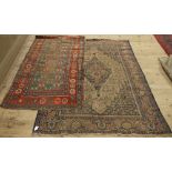 An indigo ground Persian rug with central cream lozenge design and another,