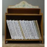 A Peter Rabbit beech bookshelf with paper label containing a quantity of Beatrix Potter books