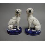 A pair of Staffordshire figures of seated,