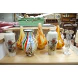 Three yellow and orange art glass vases, another with multi colour striations on a white ground,