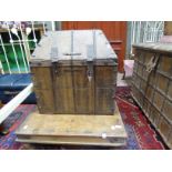 An Indian hardwood and brass bound trunk with high domed cover, rectangular base,