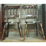 A pair of stained beech lathe back kitchen chairs