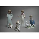 A Lladro group, the Goose Girl; a Lladro figure of a puppy and snail; two Nao figures,