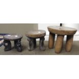 Three carved Indian wood stools, each with circular tops,