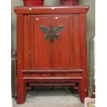 A large red painted soft wood Chinese side cabinet with butterfly lock plate,