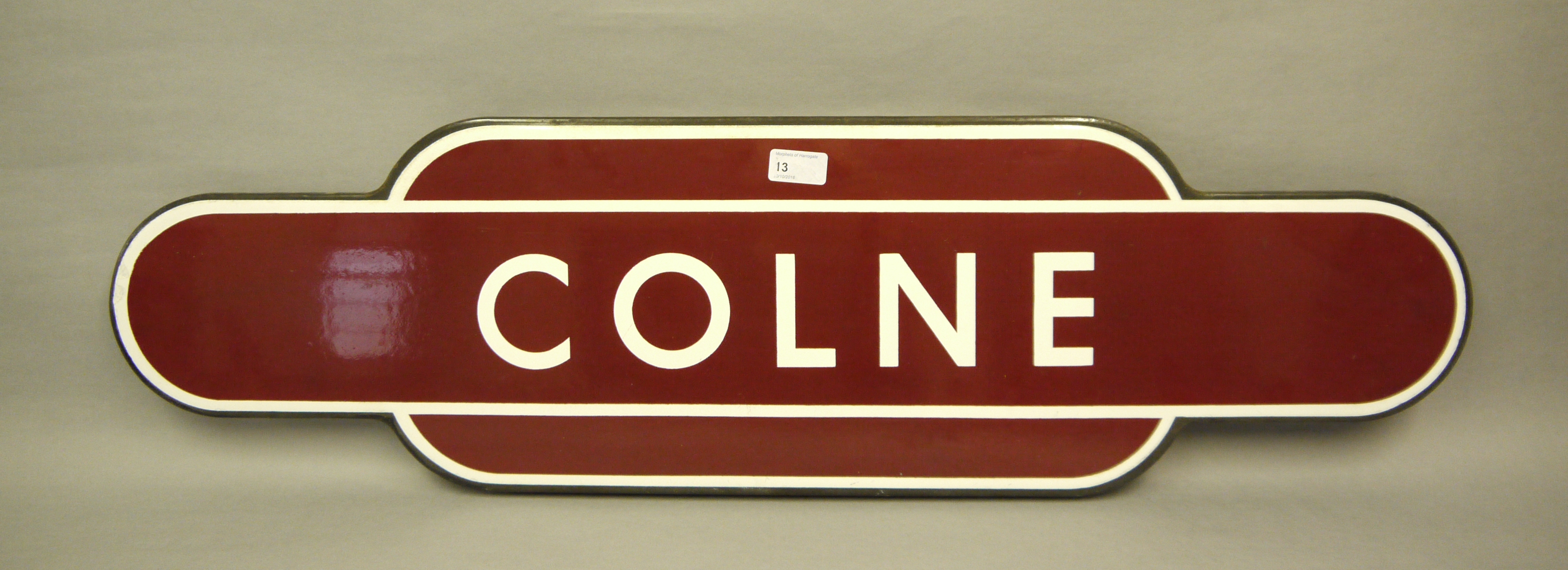 A British Rail Totem 'COLNE' metal station sign in crimson and white enamel, 92.