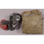 A WWII army gas mask and canvas khaki bag stamped VI M & Co 1941