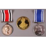 An Elizabeth II Police Exemplary Service Medal cased, Special Constabulary Medal cased,