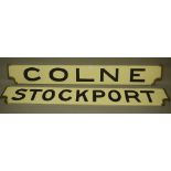 Two railway destination boards COLNE and STOCKPORT, in white with black lettering,