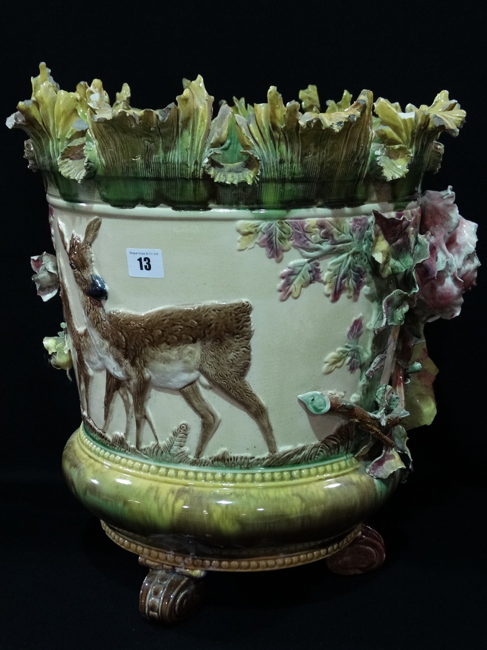 A Majolica Glazed Three Footed Relief Moulded Jardiniere