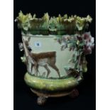 A Majolica Glazed Three Footed Relief Moulded Jardiniere