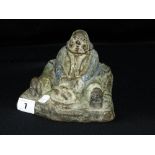 A Cast Metal Inkwell In The Form Of A Seated Figure Carving Chicken