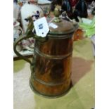 A Copper And Brass Handled Lidded Jug