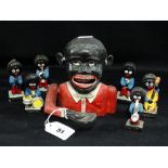 Seven Golly Musician Figures Together With A Cast Metal Money Bank
