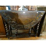 An Early 20th Century Carved Oak Gate Legged Dining Table