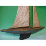 Pond Yacht The wood hull with weighted keel and linked rudder. c1920s. 36" long.