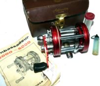 REEL: Abu Ambassadeur 6000 red multiplier reel, grooved  end plates, black handle, foot