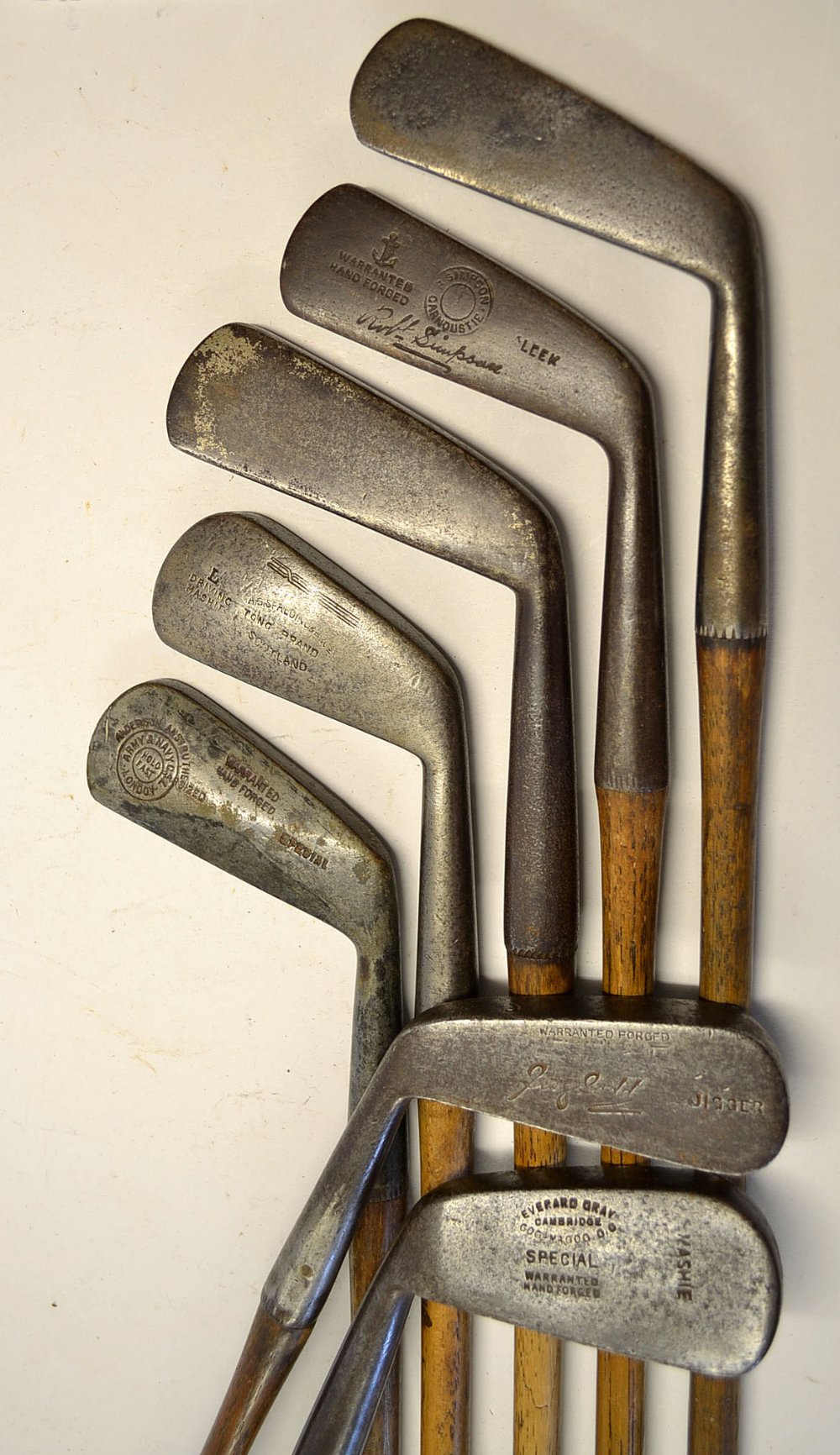 7x Various irons to include 2 left hand irons a mashie and a jigger, 4 smooth faced long irons et al