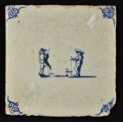 Dutch Delft Kolfing Scene Tile in blue and white with decorative design to the corners and two