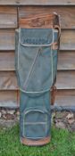 Good leather and canvas oval golf bag with ball pocket, original shoulder strap and travel hood some